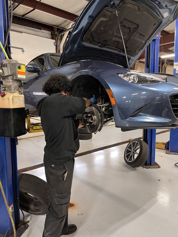 a mechanic performing brake replacement 